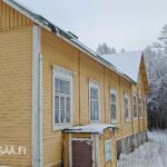 Näkymä keltaisen koulurakennuksen pitkälle sivulle ja vanhaan ikkunarivistöön.